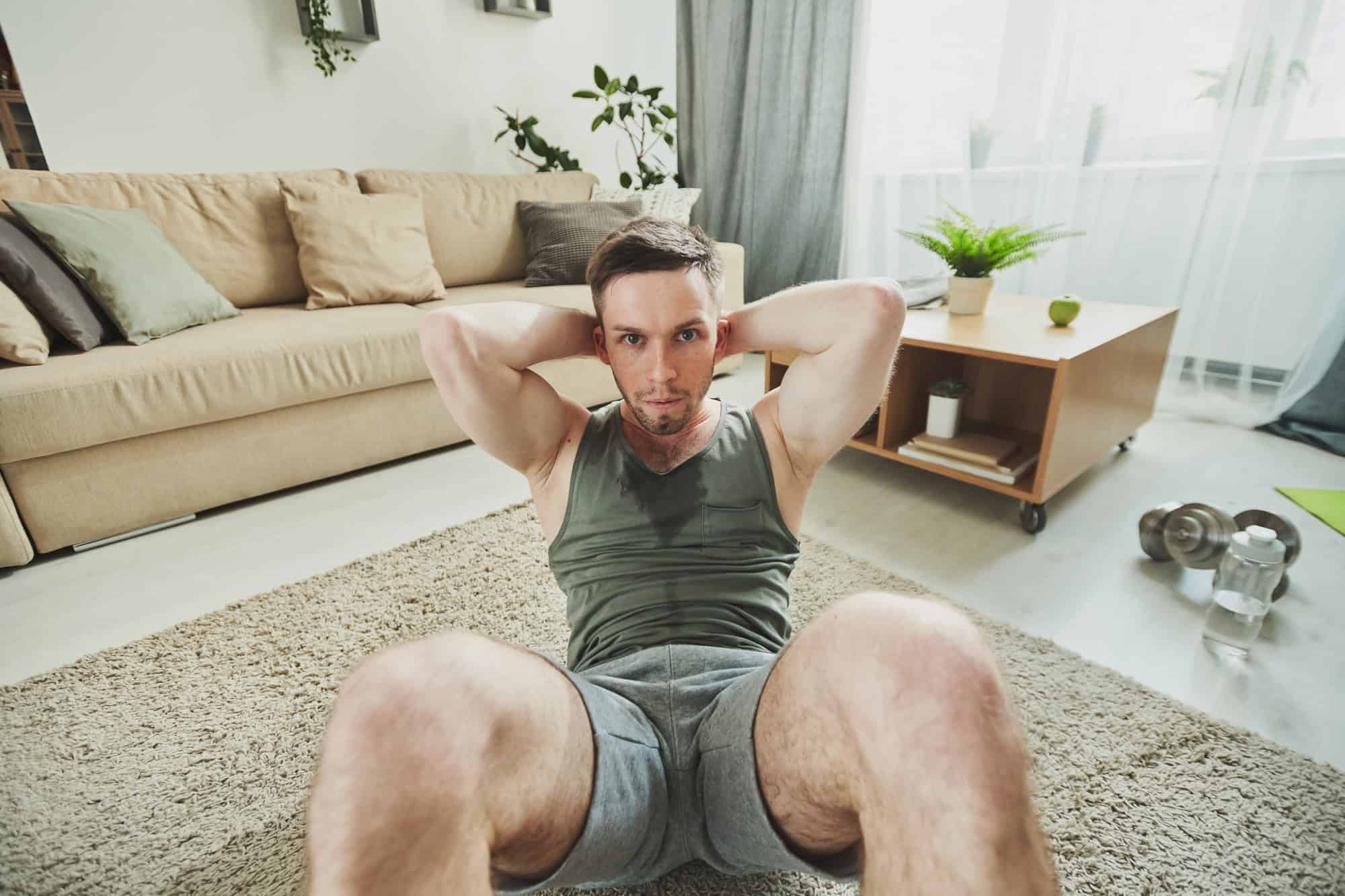 Man doing sit-ups as part of full body exercises