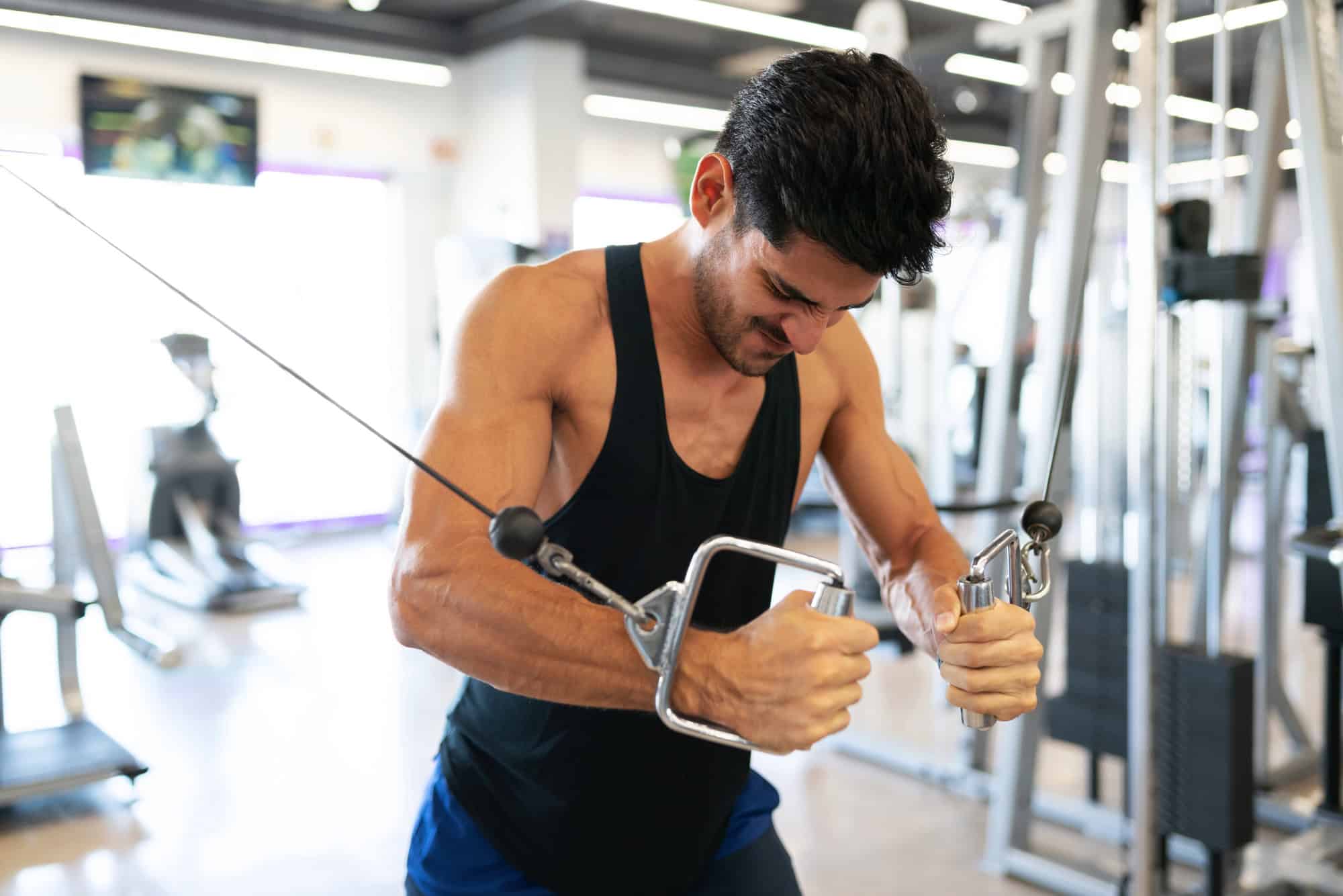  Man doing cable chest fly to target the pectoral muscles with consistent resistance