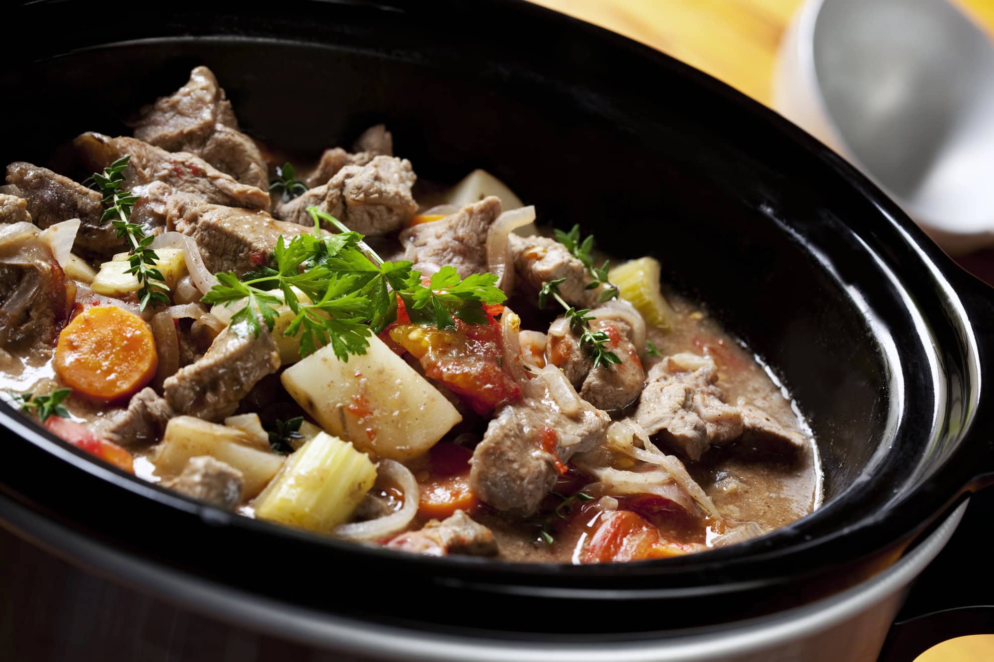 Slow-cooked beef and vegetable stew in a crockpot as a high protein crockpot meal for easy, muscle-friendly meal prep