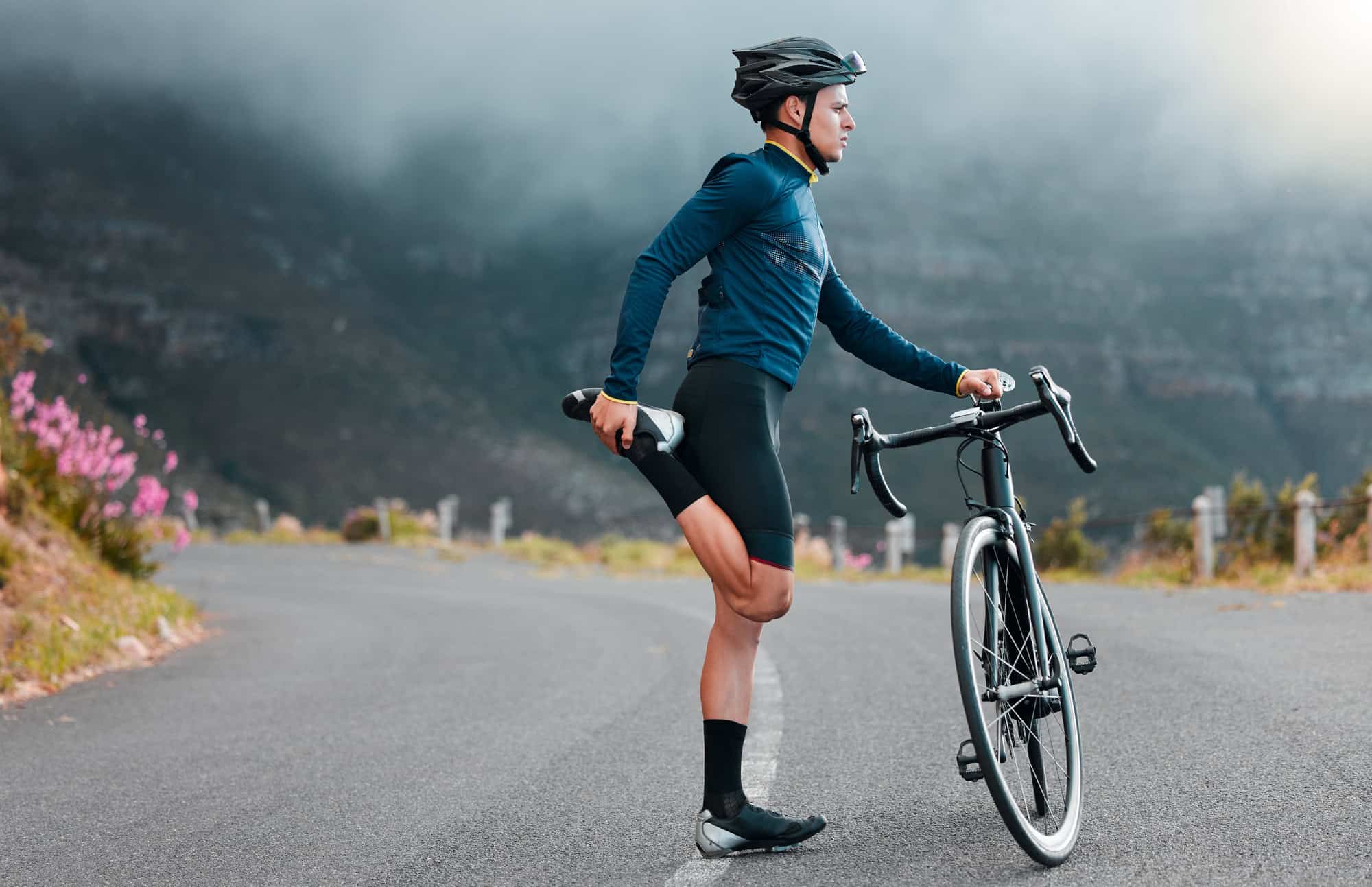 Man stretching before riding his bicycle - How to start working out again after knee injury